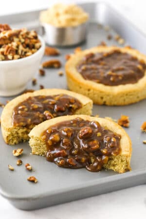 A pecan pie cookie cut in half with the homemade filling oozing out