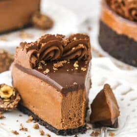 A slice of no bake Nutella cheesecake on a plate with one bite on a fork