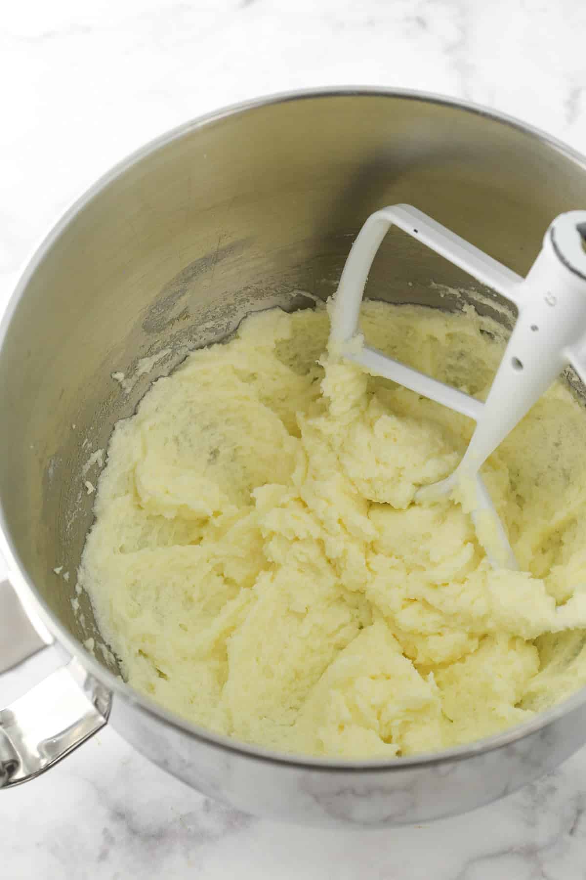 A light and fluffy butter, sugar and egg mixture in a metal bowl