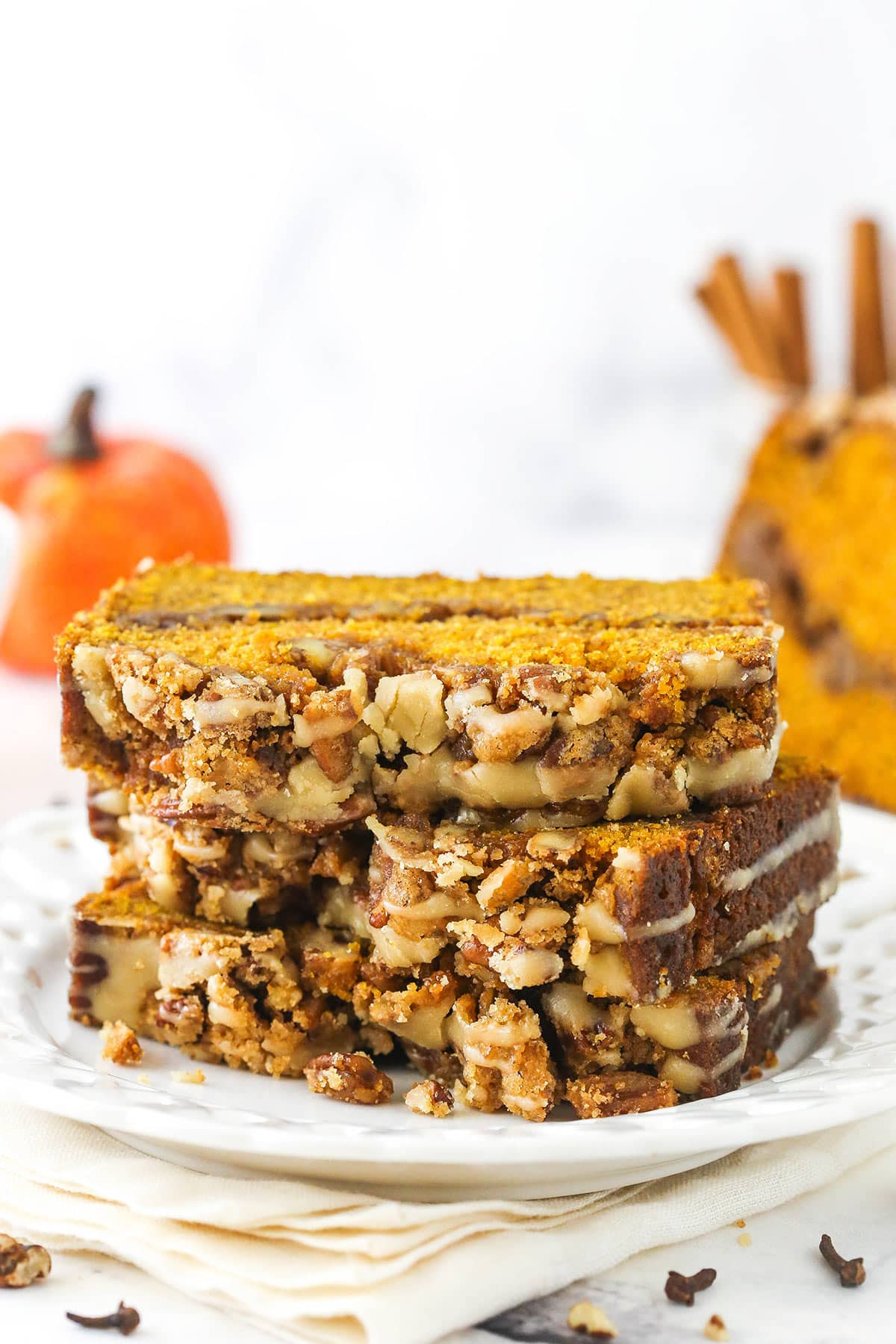 Three pieces of pecan praline pumpkin bread stacked on top of each other