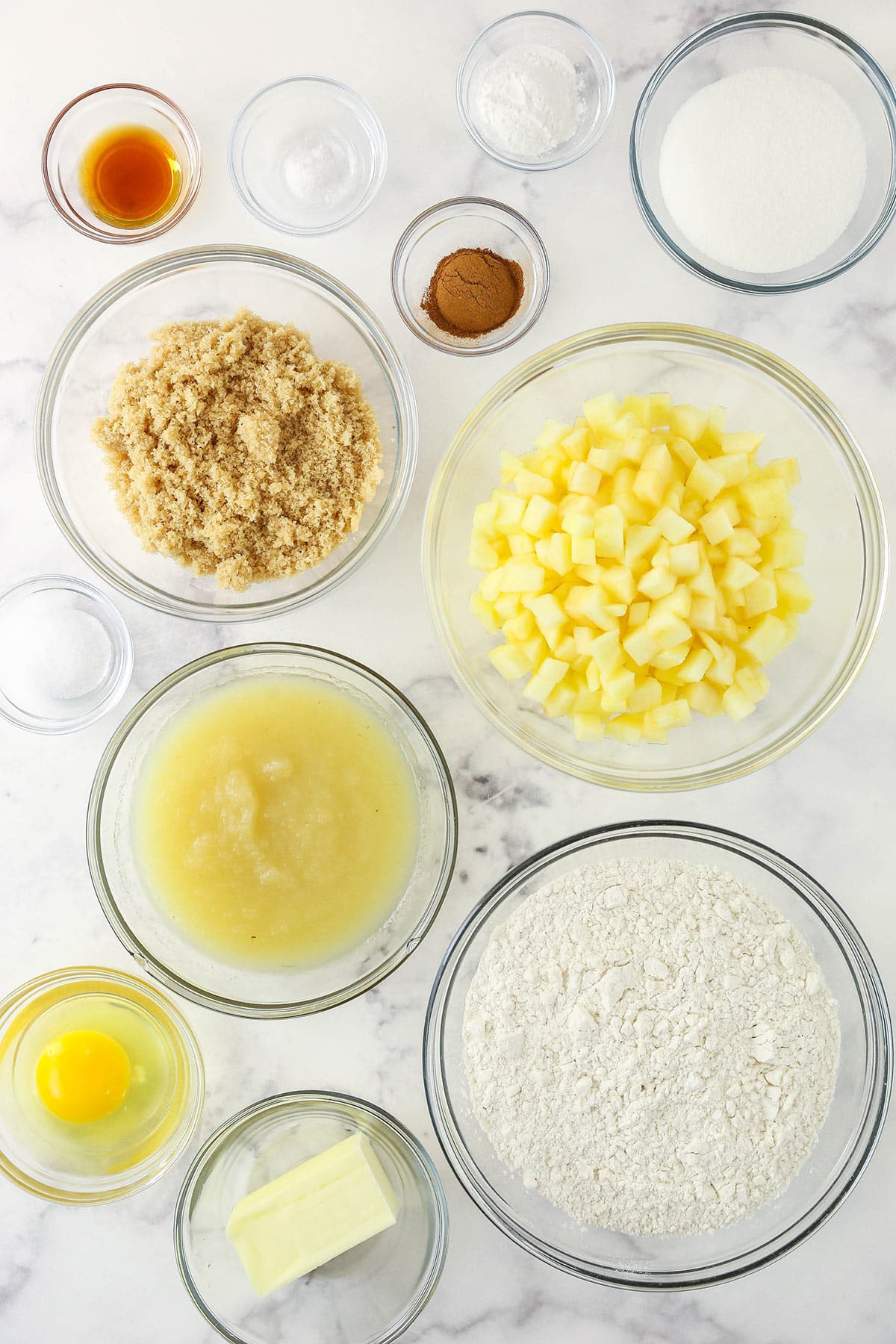 muffin ingredients in bowls on marble countertop