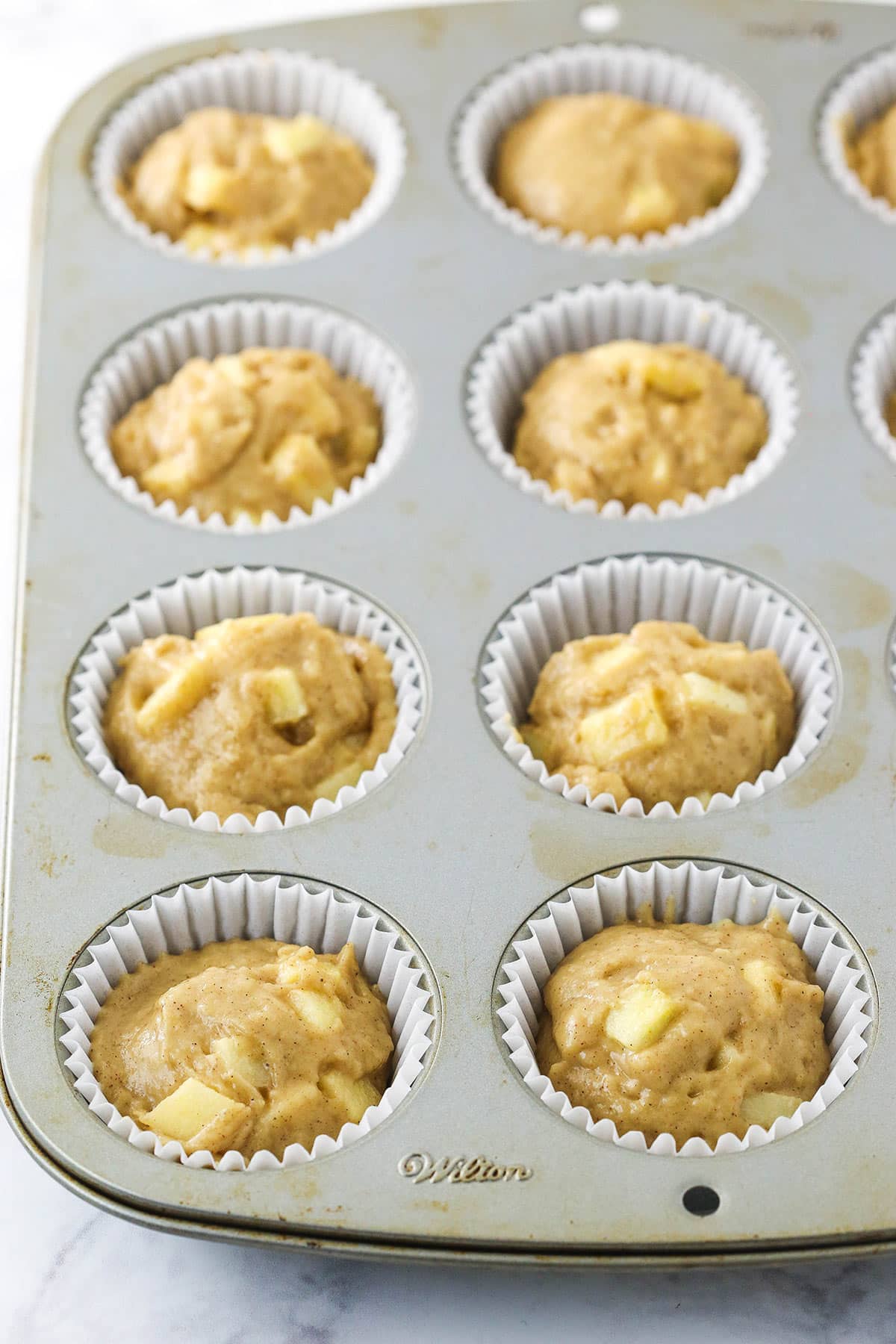 unbaked apple muffins without streusel in the muffin pan