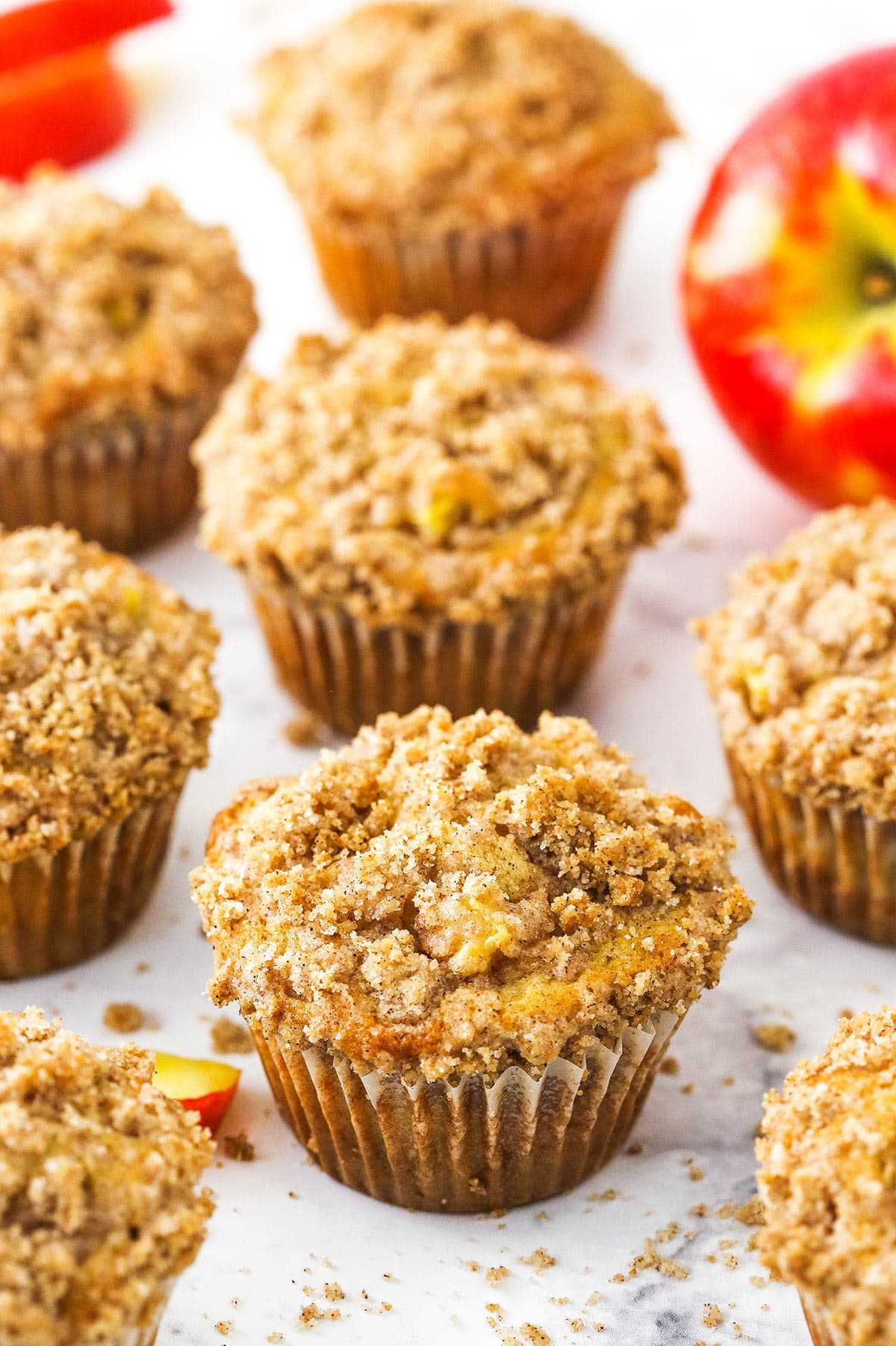 cinnamon apple streusel muffins on a marble table