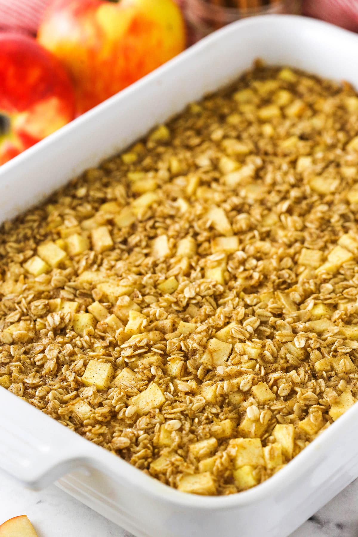 A batch of apple cinnamon baked oatmeal inside of a large baking dish with handles