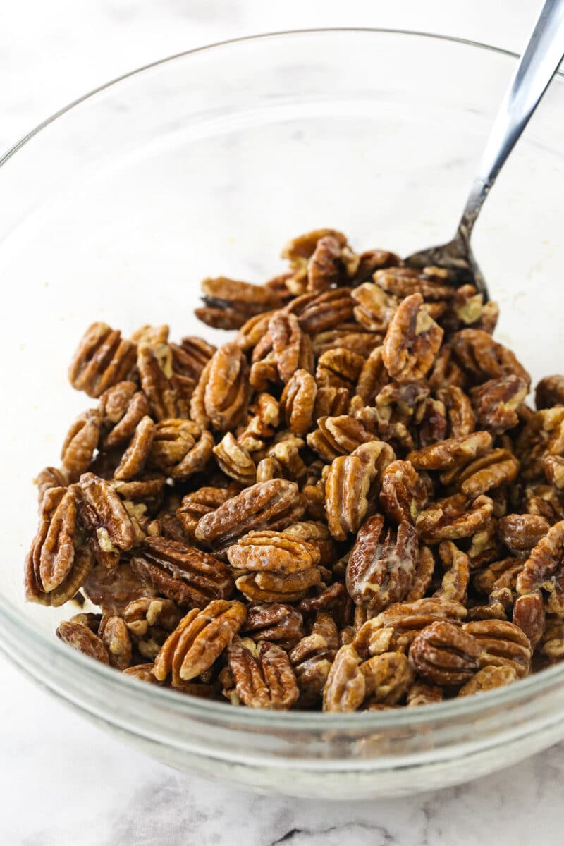 A bowl of pecans coated in a mixture of whipped egg white, vanilla, and butter.