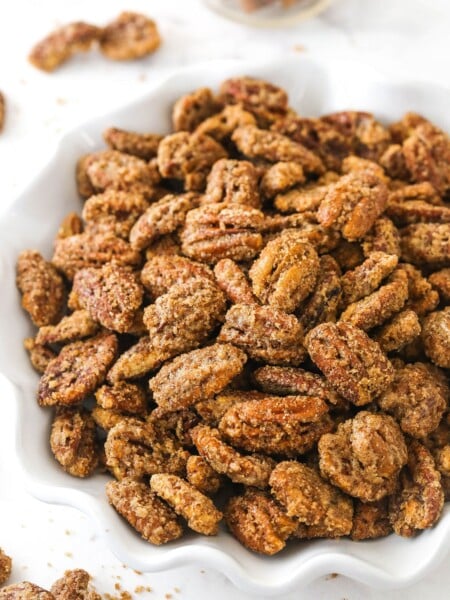 A bowl of cinnamon sugar pecans on a kitchen countertop