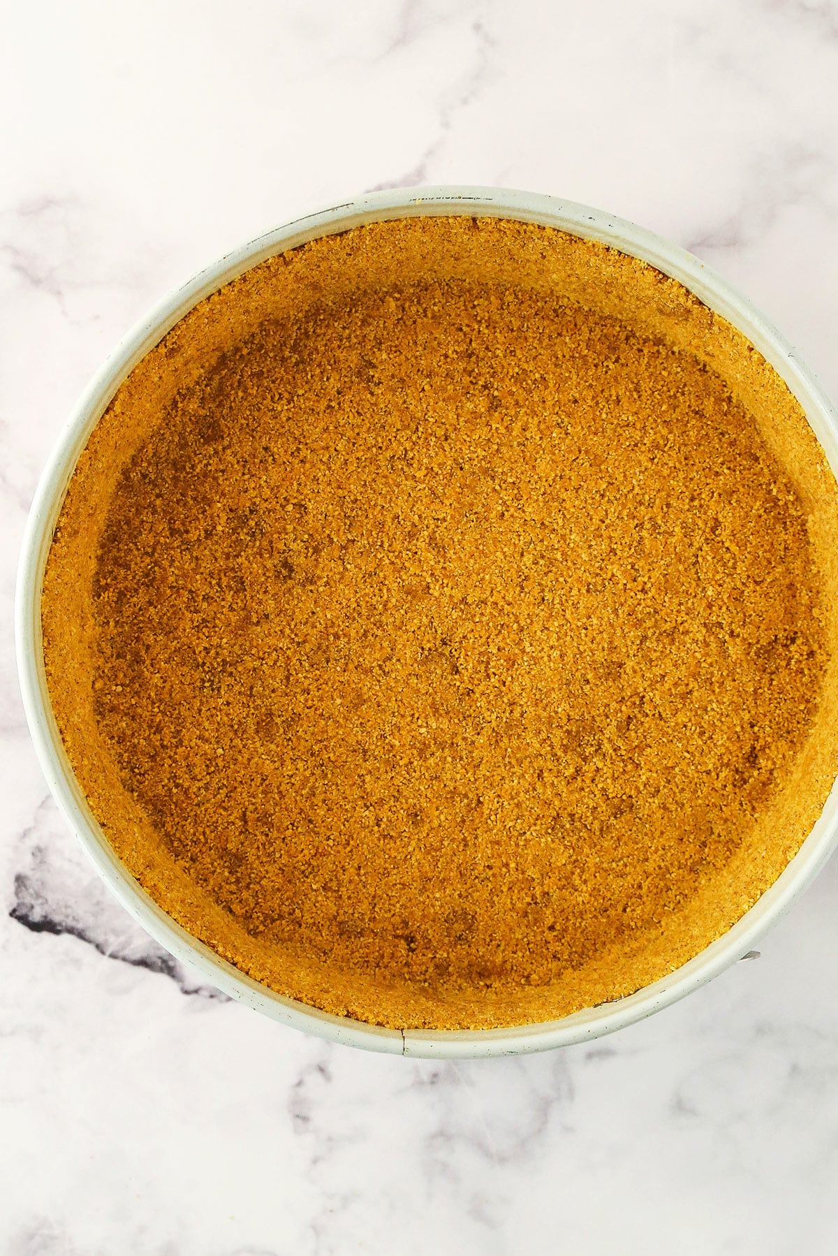 This thick and creamy Pumpkin Cheesecake features a buttery graham cracker crust and fluffy swirls of whipped cream cheese frosting! A graham cracker crust pressed firmly into a springform pan