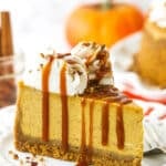 A slice of pumpkin cheesecake topped with a drizzle of homemade caramel sauce
