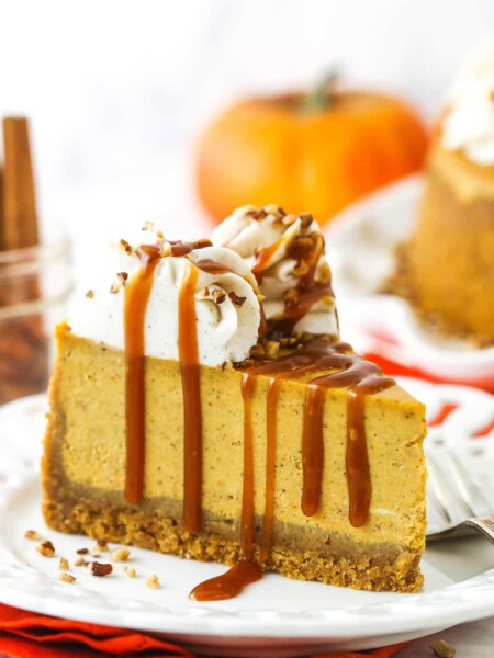 A slice of pumpkin cheesecake topped with a drizzle of homemade caramel sauce
