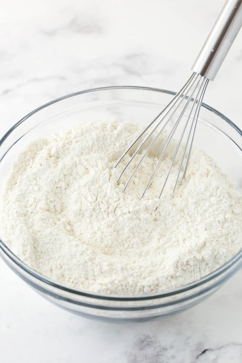 The combined dry ingredients in a bowl with a metal whisk