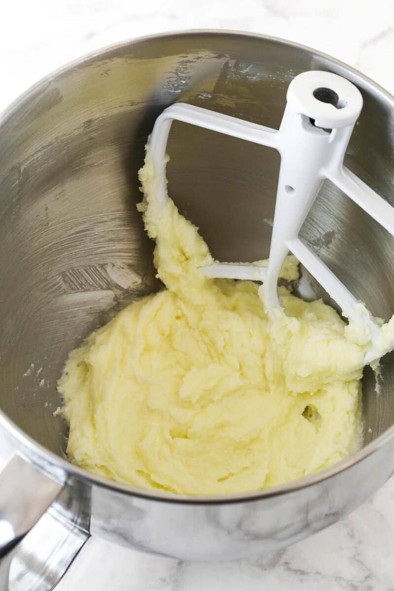 Fully creamed butter and sugar inside of an electric mixing bowl