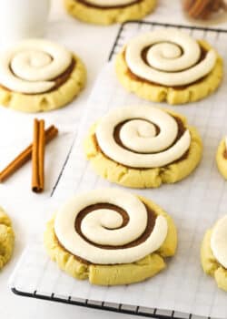 Copy cat Crumbl cookies on a wire rack lined with a sheet of parchment paper