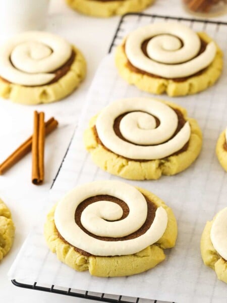 Copy cat Crumbl cookies on a wire rack lined with a sheet of parchment paper