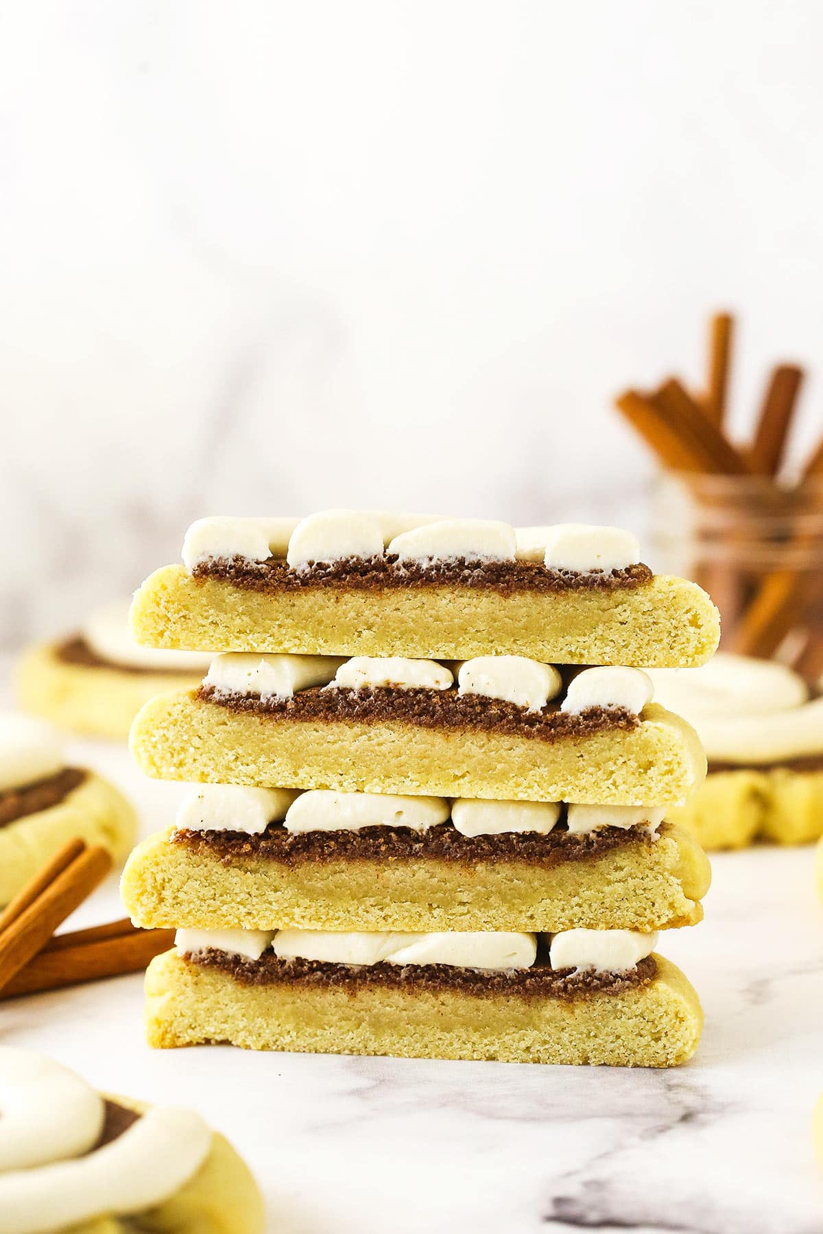 Two halved cinnamon roll cookies stacked on top of each other