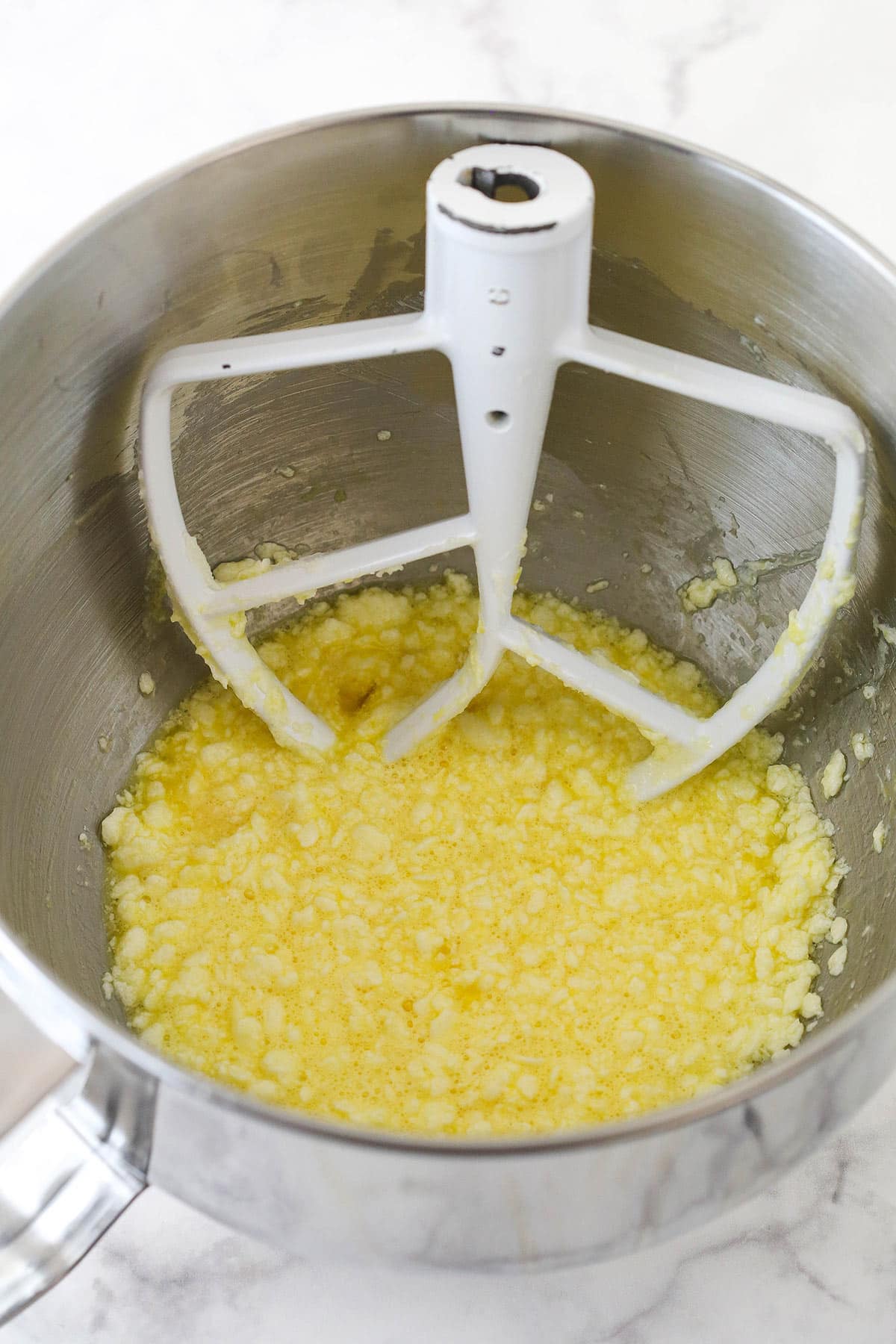 Mixing eggs into creamed butter and sugar