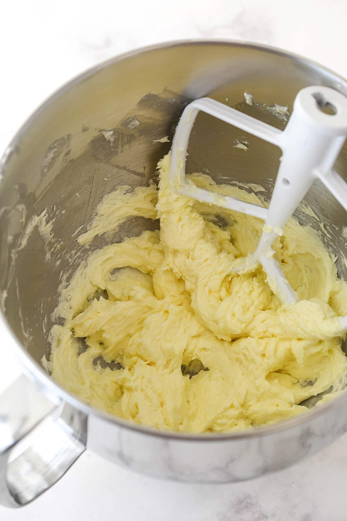 Mixing in egg into the creamed butter and sugar