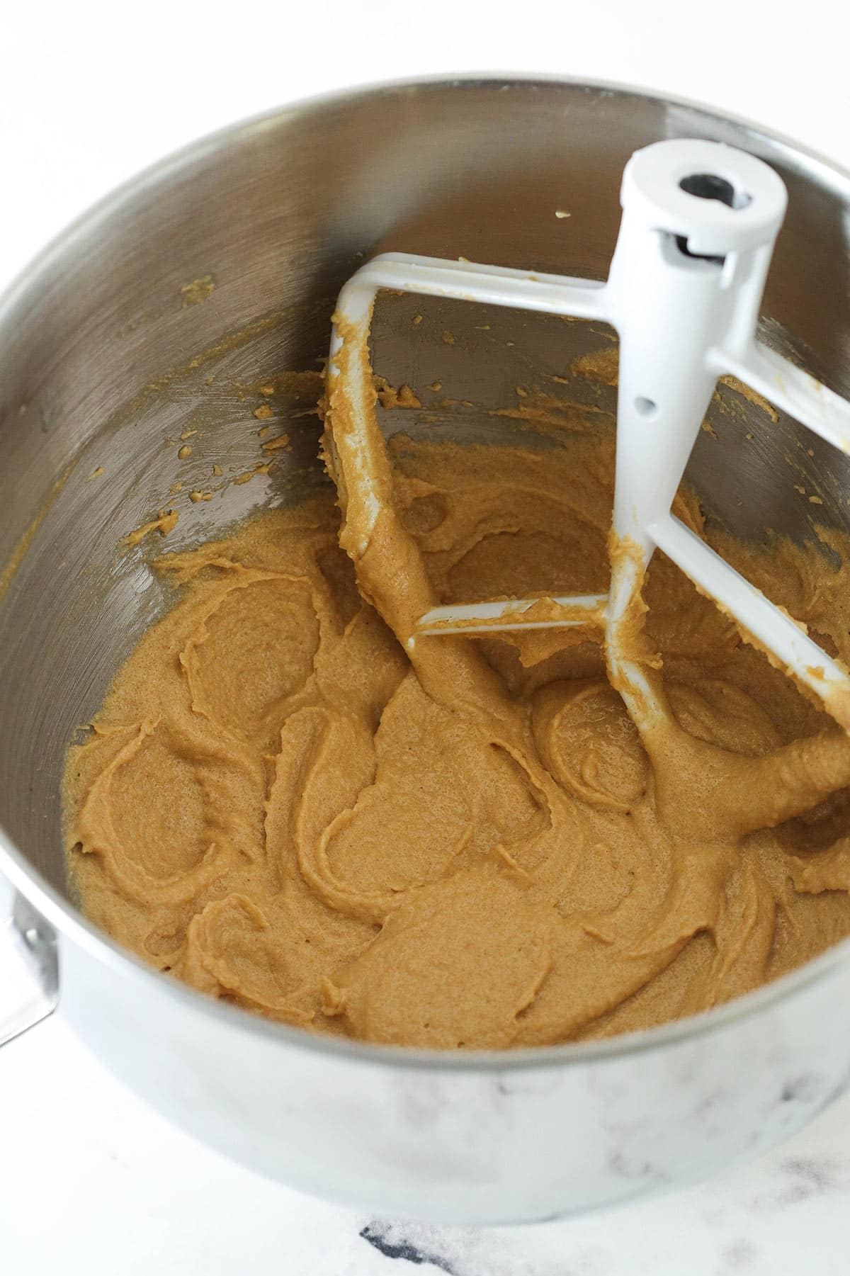 Creaming together butter, peanut butter, sugar and brown sugar in a mixing bowl