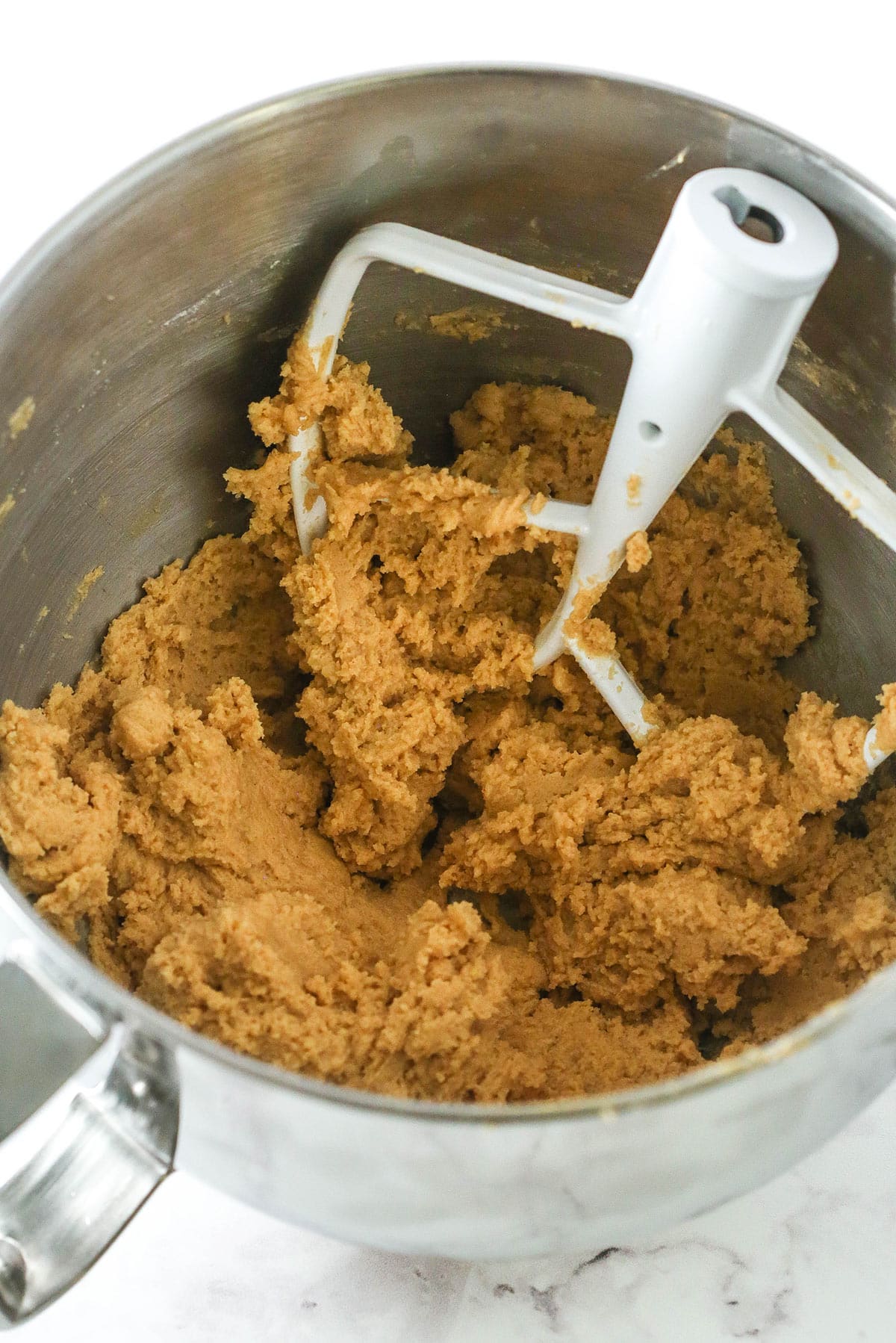 Peanut butter cookie dough in a mixing bowl