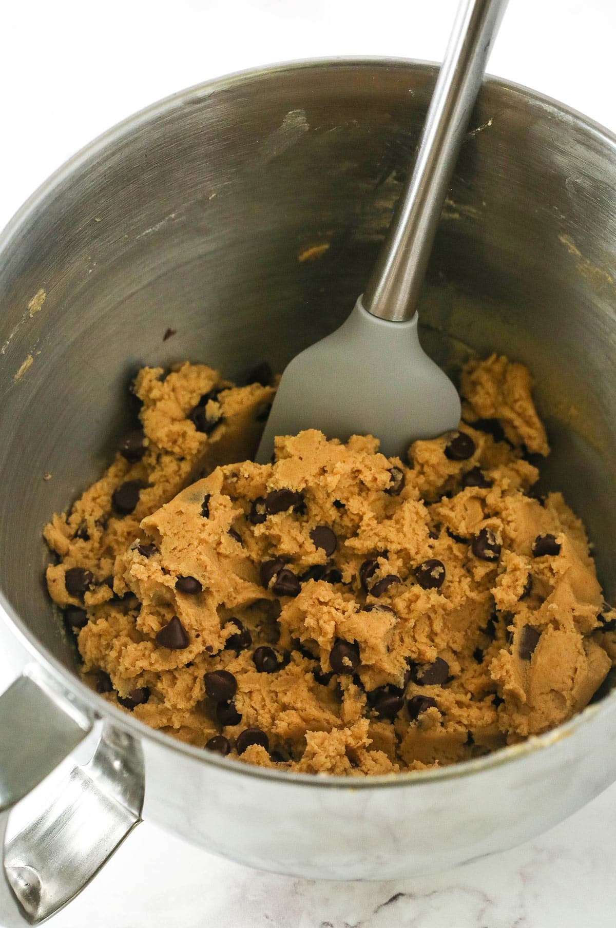 Mixing in chocolate chips to the peanut butter cookie dough
