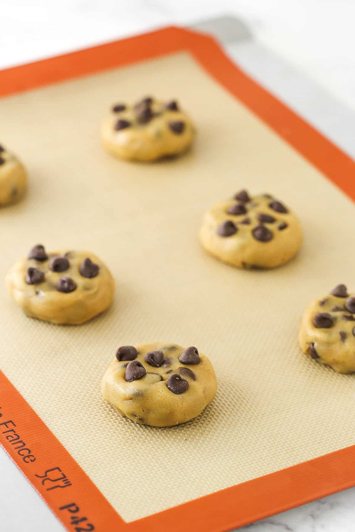Cookie dough balls on a silicone baking mat