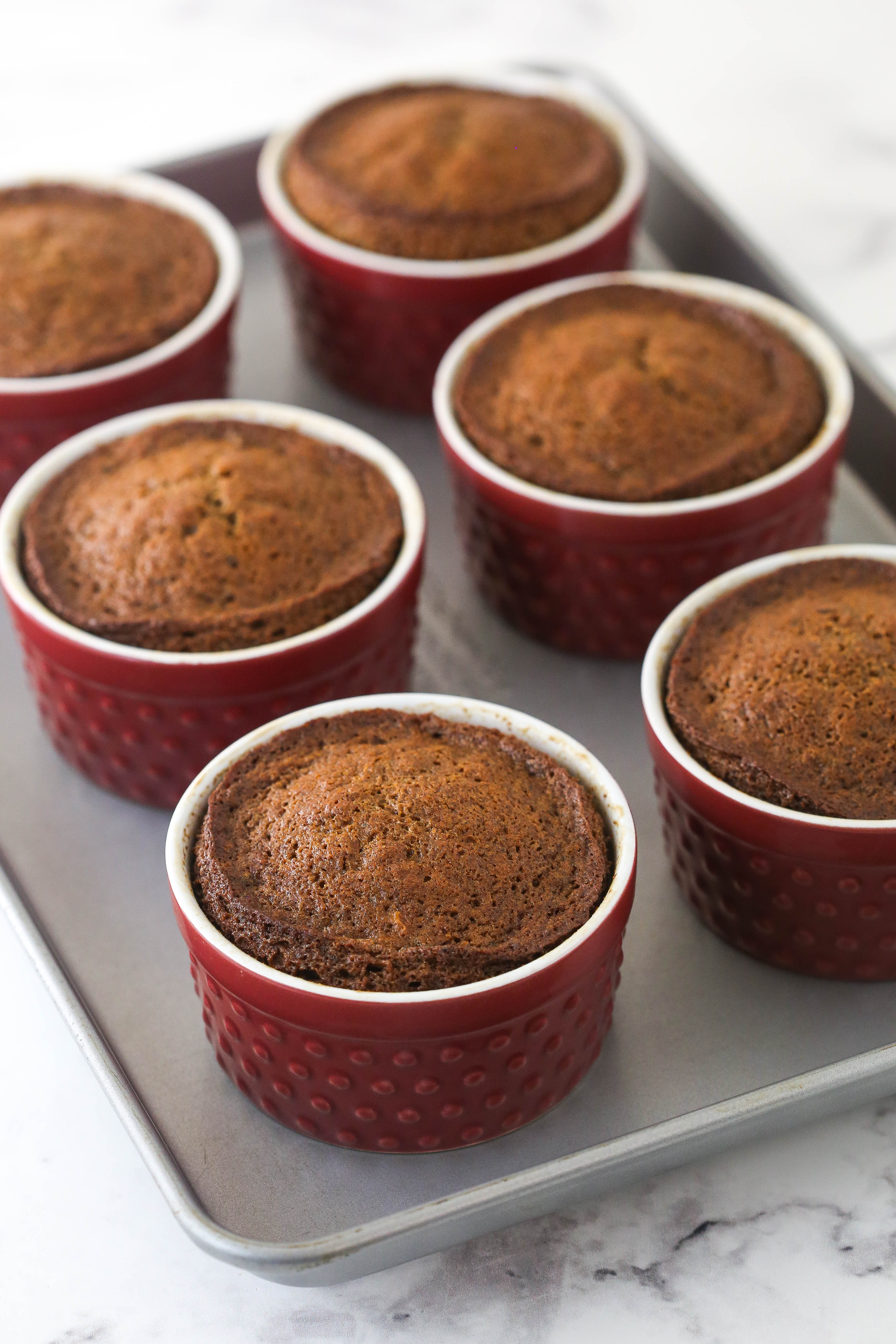 Baked sticky toffee puddings in red ramikins