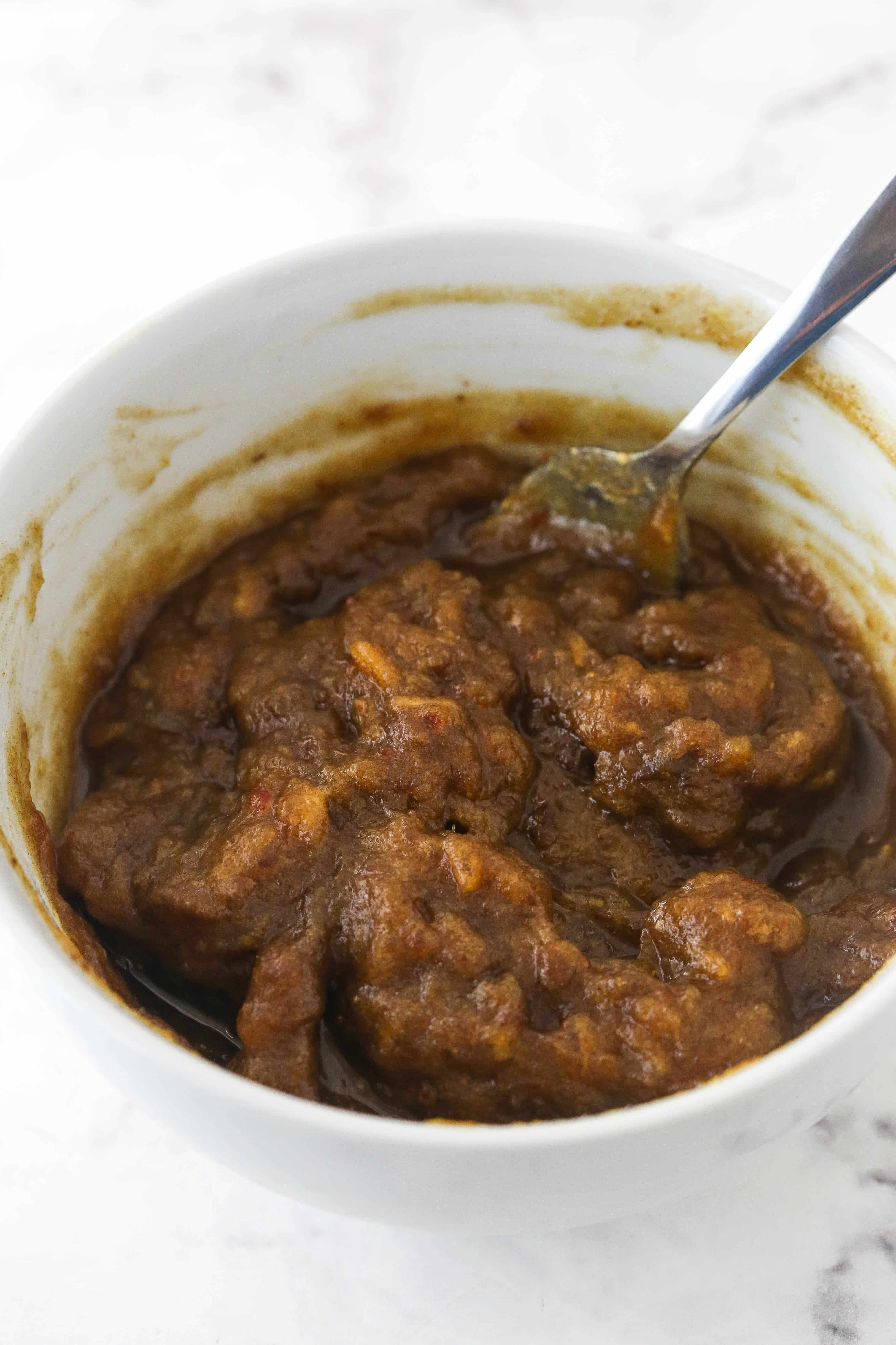 Mashed up dates in a white bowl