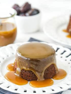 Sticky toffee pudding on a white serving plate