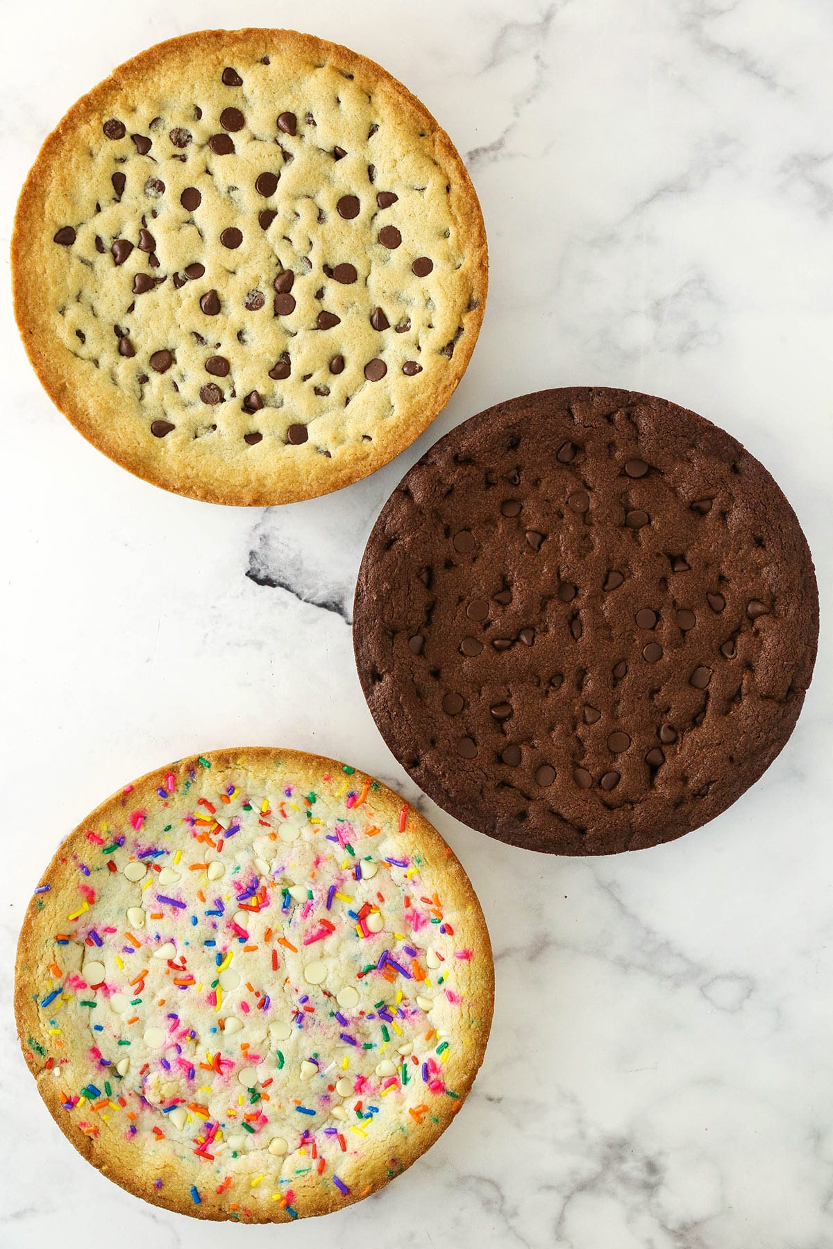 image of the three baked cookies sitting on a marble countertop