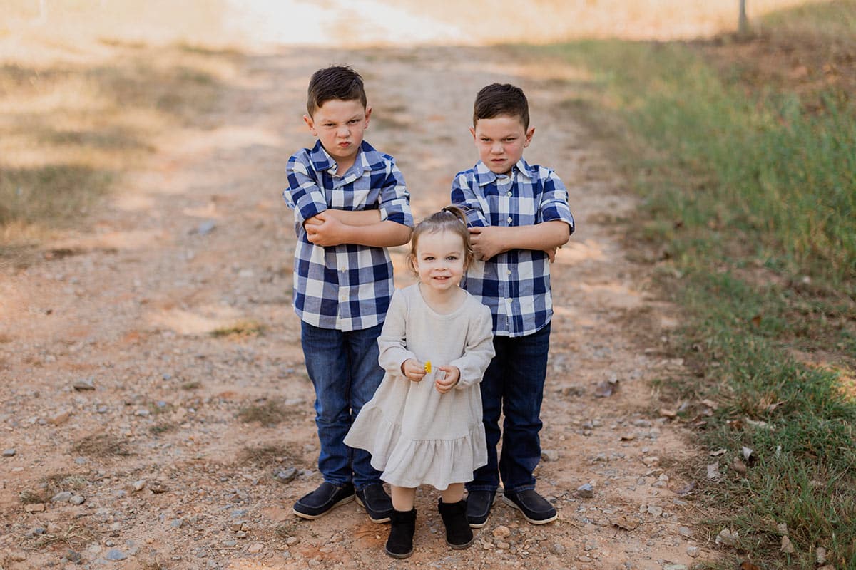 the boys crossing their arms while standing behind mckenzie