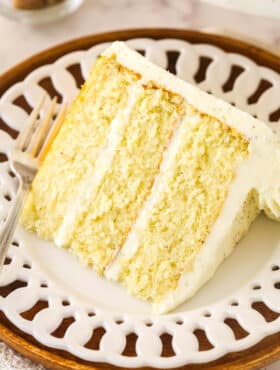 A slice of eggnog cake on a white serving plate