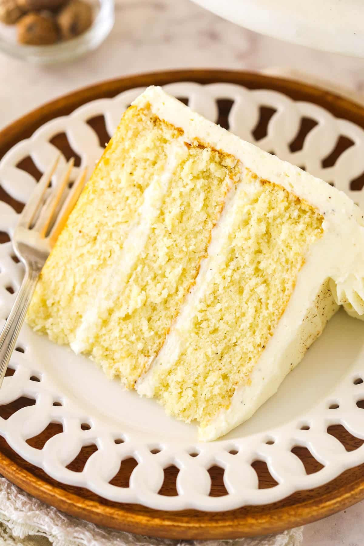 A slice of eggnog cake on a white serving plate