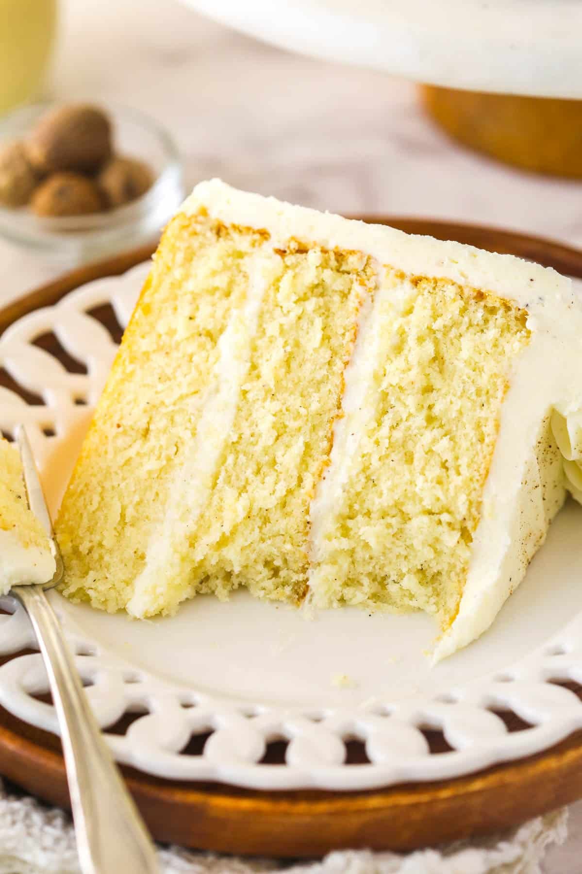 A slice of eggnog cake with a big bite missing