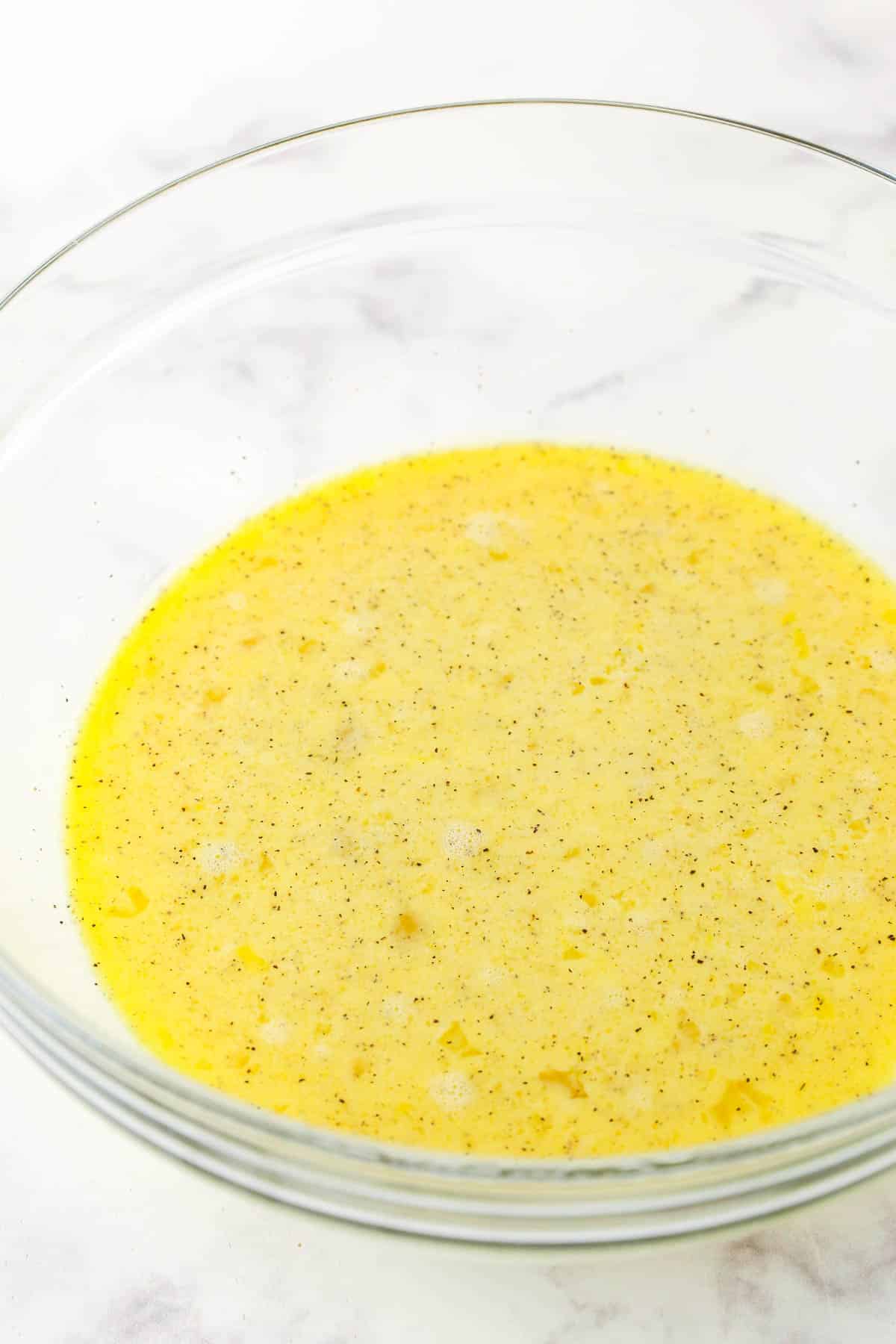 This Hashbrown Breakfast Casserole is perfect when you need to feed a crowd in the morning. Perfect for Christmas, Thanksgiving, or brunch! Eggs, milk, salt, and pepper whisked together in a bowl