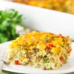 A piece of hashbrown breakfast casserole on a plate ready to be eaten