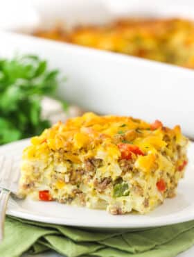 A piece of hashbrown breakfast casserole on a plate ready to be eaten