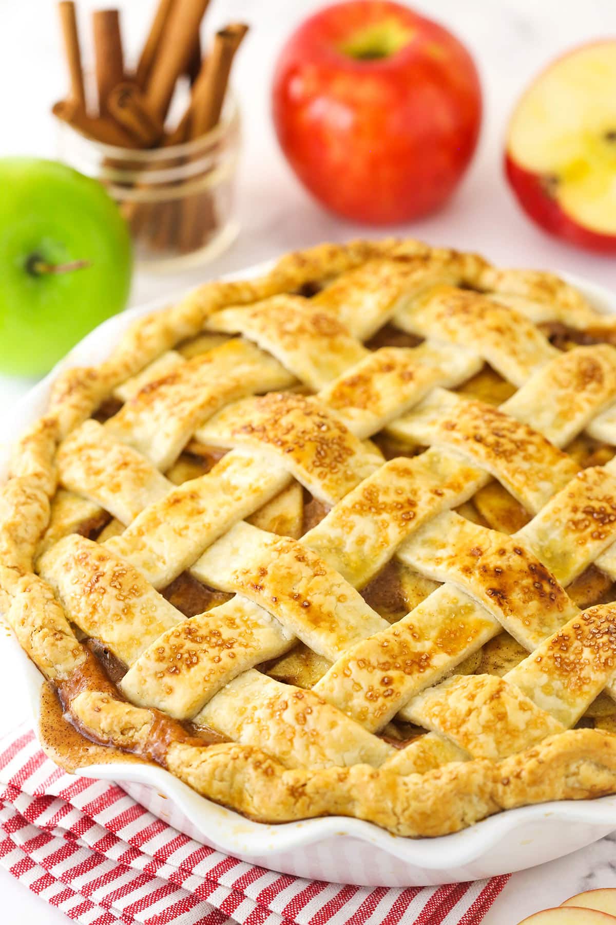 Cooked homemade apple pie cooling in a pie plate.