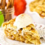 A slice of apple pie with vanilla ice cream on top.