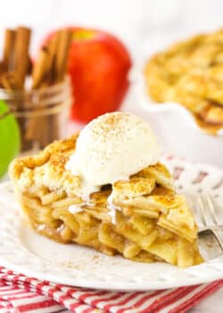 A slice of apple pie with vanilla ice cream on top.