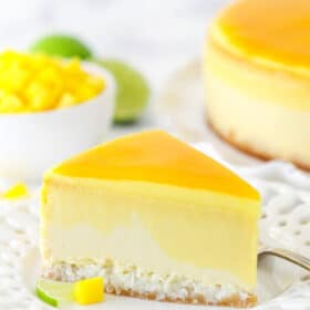 slice of mango key lime cheesecake on white plate