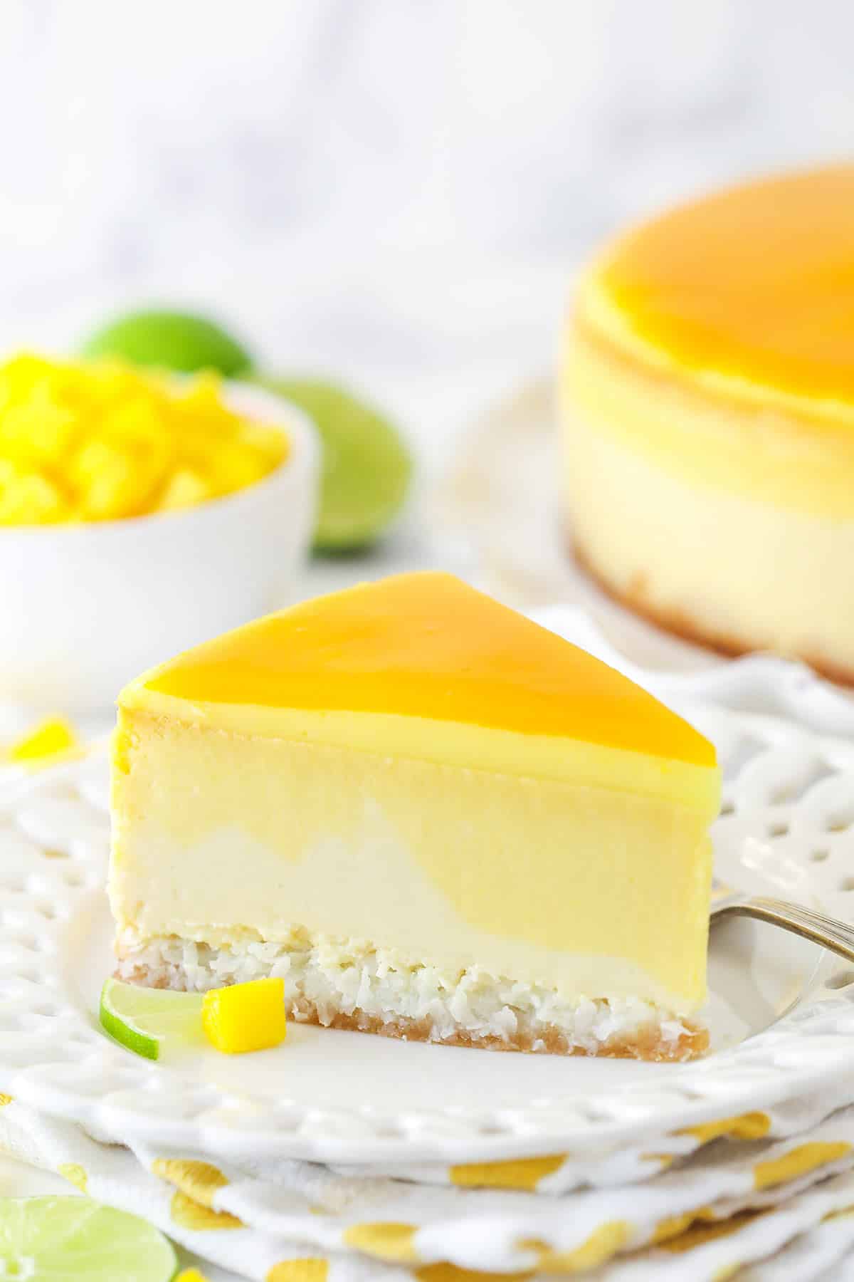 slice of mango key lime cheesecake on white plate