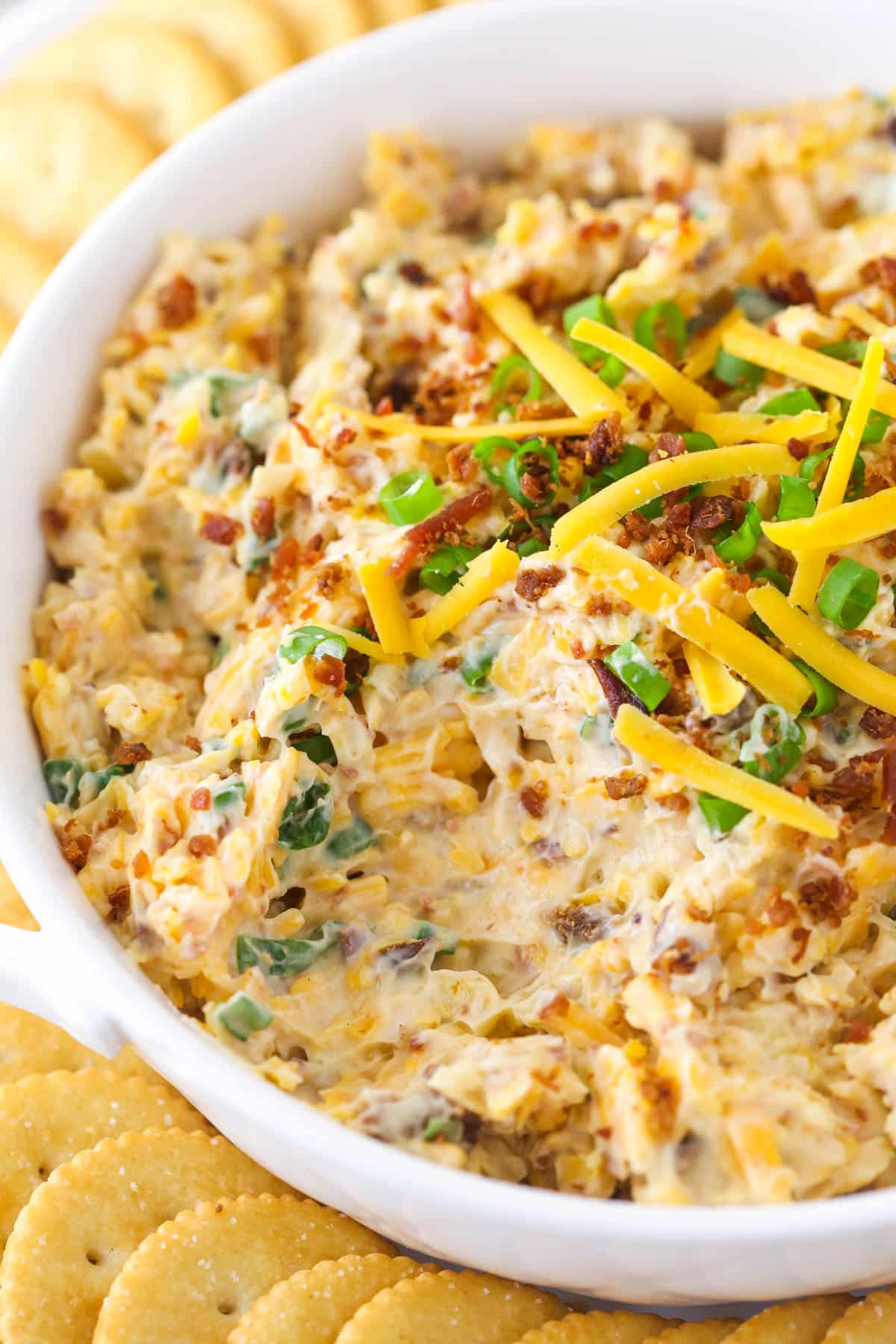 Million Dollar Dip is quick and made with only 5 ingredients - bacon, cheese, green onions, almonds, and mayo. A perfect game day snack! million dollar dip with a big scoop missing