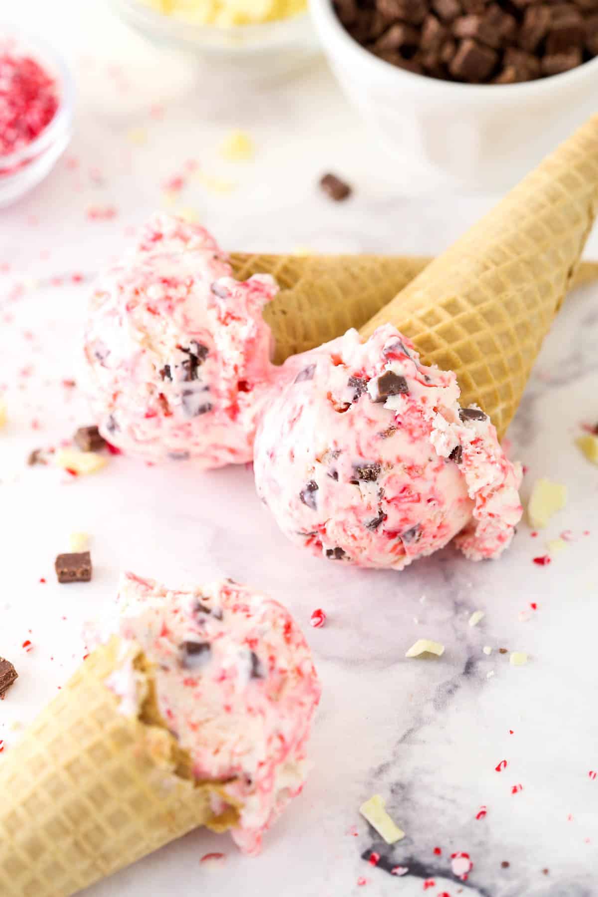 Three ice cream cones with scoops of peppermint bark ice cream