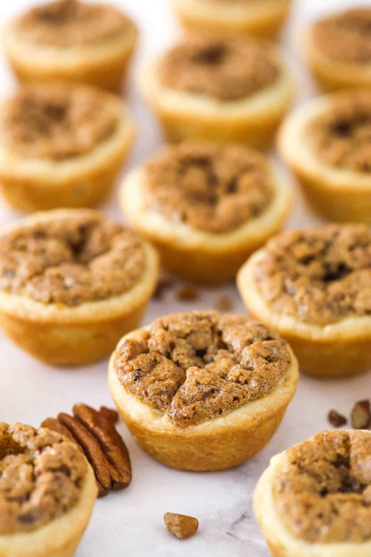 Close up of pecan tassies on a white counter