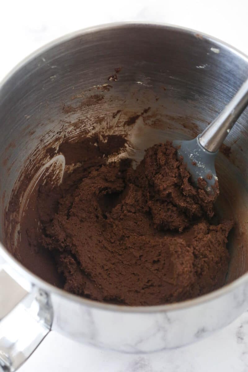 Adding the dry ingredients to the creamed butter and sugar.