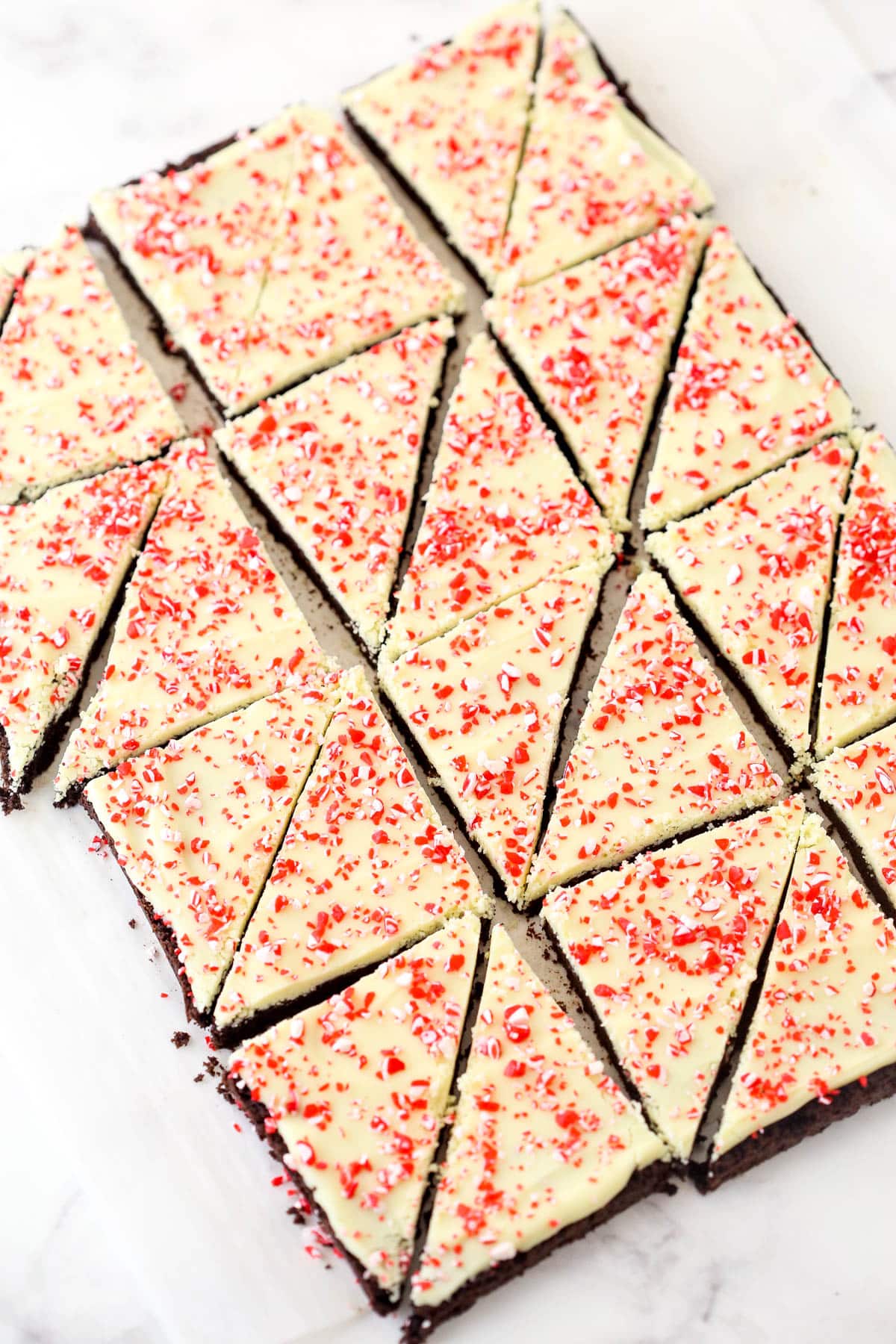 Cutting peppermint bark cookies into triangles.