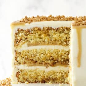 toffee cake with a slice cut out sitting on cake stand