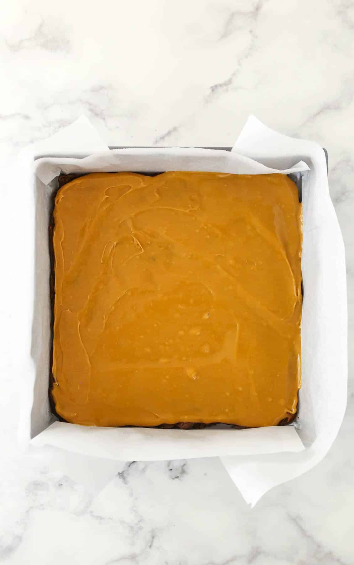 Adding the caramel layer to the turtle fudge