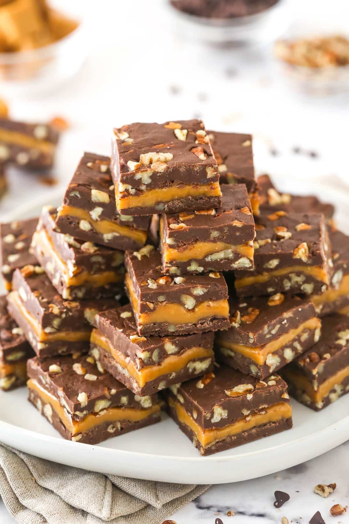 A platter with stacked pieces of turtle fudge