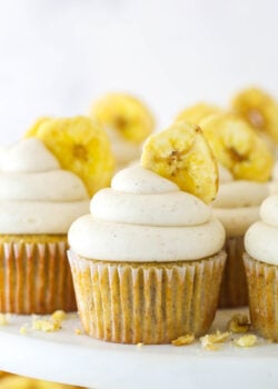 Banana cupcakes with cinnamon cream cheese frosting and a banana chip.