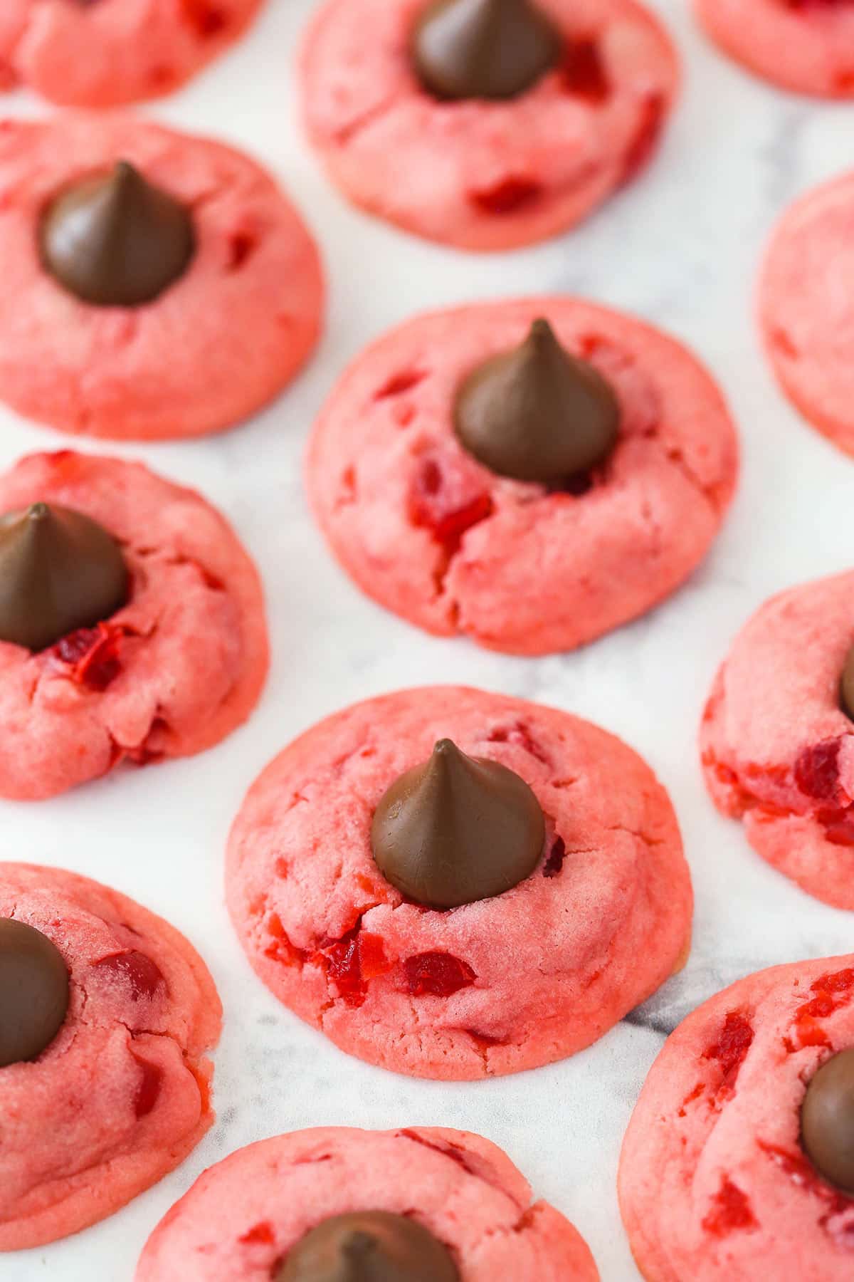Wonderfully cute, these cherry chocolate kiss cookies are the perfect holiday treat. The secret to their flavor? Cherry juice. Lots of cherry Kiss cookies.